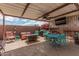 Relaxing backyard features a covered patio, hot tub, a bar with an outdoor tv, and comfortable seating at 13146 S 178Th Ave, Goodyear, AZ 85338