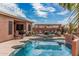 Beautiful backyard showcasing a sparkling pool, covered patio, and lush landscaping, perfect for relaxing at 13146 S 178Th Ave, Goodyear, AZ 85338