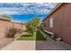 A serene backyard features a narrow lawn, trees, and manicured landscaping, offering a peaceful retreat at 13146 S 178Th Ave, Goodyear, AZ 85338