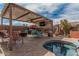 Inviting backyard with covered patio, hot tub, a bar with an outdoor tv, and comfortable seating at 13146 S 178Th Ave, Goodyear, AZ 85338
