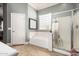Bathroom featuring a soaking tub and a separate glass-enclosed shower for spa-like experience at 13146 S 178Th Ave, Goodyear, AZ 85338