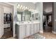 Bathroom with double vanity sinks, and a walk-in closet in the background at 13146 S 178Th Ave, Goodyear, AZ 85338