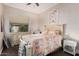 Cozy bedroom featuring a patterned quilt, dresser, and a window with natural light at 13146 S 178Th Ave, Goodyear, AZ 85338