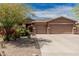 Charming home featuring a three-car garage, tile roof, and desert landscaping at 13146 S 178Th Ave, Goodyear, AZ 85338