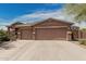 Charming home featuring a three-car garage and professionally landscaped front yard at 13146 S 178Th Ave, Goodyear, AZ 85338