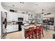 Bright kitchen features white cabinets, granite counters, and an island with bar seating at 13146 S 178Th Ave, Goodyear, AZ 85338