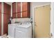 Functional laundry room equipped with a washer, dryer, and ample cabinet space at 13146 S 178Th Ave, Goodyear, AZ 85338