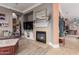 Cozy living room featuring a fireplace, TV, and stylish decor with bright and natural light at 13146 S 178Th Ave, Goodyear, AZ 85338
