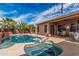 A beautiful backyard pool and spa with a tanning ledge offers a relaxing oasis at 13146 S 178Th Ave, Goodyear, AZ 85338
