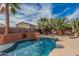 Backyard pool features palm trees, a sun-soaked deck, and vibrant landscaping for a relaxing oasis at 13146 S 178Th Ave, Goodyear, AZ 85338