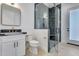 Stylish bathroom with a glass-enclosed shower, modern fixtures, and sleek black and white design at 1602 E Cloud Rd, Phoenix, AZ 85086