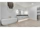 Bright bathroom featuring a modern soaking tub, dual vanities, and a decorative chandelier at 1602 E Cloud Rd, Phoenix, AZ 85086