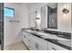 Bathroom featuring dual sinks, granite countertops, modern light fixtures, and large mirrors at 1602 E Cloud Rd, Phoenix, AZ 85086