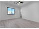 Bright bedroom with light wood floors, a black-framed window, and fresh paint at 1602 E Cloud Rd, Phoenix, AZ 85086