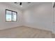 A bright bedroom with wood-look floors, neutral paint, a ceiling fan, and views to the outside at 1602 E Cloud Rd, Phoenix, AZ 85086