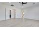 An open bedroom with hardwood floors, a ceiling fan, and a view of the connected bathroom at 1602 E Cloud Rd, Phoenix, AZ 85086