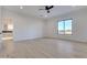 Bright, open bedroom with hardwood floors, modern ceiling fan, and large window with desert views at 1602 E Cloud Rd, Phoenix, AZ 85086