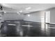 Spacious garage with speckled epoxy flooring, ample lighting, and a side entry door at 1602 E Cloud Rd, Phoenix, AZ 85086