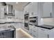 A modern kitchen boasts sleek white cabinetry, state-of-the-art stainless steel appliances, and elegant countertops at 1602 E Cloud Rd, Phoenix, AZ 85086