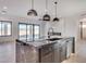 Open kitchen with a large center island, dark wood cabinets, light countertops, and modern pendant lights at 1602 E Cloud Rd, Phoenix, AZ 85086