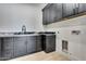 Laundry area with granite counters, black cabinets and modern fixtures at 1602 E Cloud Rd, Phoenix, AZ 85086