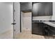 Laundry area featuring granite counters, black cabinets and laundry hookups at 1602 E Cloud Rd, Phoenix, AZ 85086