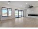 Bright living room with lots of natural light, modern ceiling fan, and sliding glass doors to the backyard at 1602 E Cloud Rd, Phoenix, AZ 85086