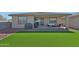 A spacious backyard with a built-in grill and outdoor seating area at 17286 W Running Deer Trl, Surprise, AZ 85387