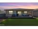 Spacious outdoor area with patio, grill, seating, and artificial turf at 17286 W Running Deer Trl, Surprise, AZ 85387