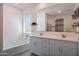 Bright bathroom with double vanity, a soaking tub, and a large mirror reflecting the space at 17286 W Running Deer Trl, Surprise, AZ 85387