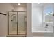 Well-lit bathroom featuring both a shower and tub, perfect for relaxation and convenience at 17286 W Running Deer Trl, Surprise, AZ 85387