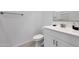 Bright bathroom featuring a modern vanity with white cabinets and a matching toilet, all set against neutral flooring at 17286 W Running Deer Trl, Surprise, AZ 85387