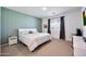 Serene bedroom with striped accent wall, carpeted flooring, and window with natural light at 17286 W Running Deer Trl, Surprise, AZ 85387