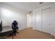 Comfortable bedroom with carpeted floors, a modern desk, and ample storage space, creating an ideal relaxation area at 17286 W Running Deer Trl, Surprise, AZ 85387