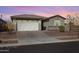 A well maintained home featuring low maintenance landscaping in the front yard at 17286 W Running Deer Trl, Surprise, AZ 85387