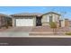Charming single-story home with a two-car garage, desert landscaping, and neutral color palette at 17286 W Running Deer Trl, Surprise, AZ 85387