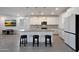 Bright, open kitchen featuring a center island with counter seating and modern stainless steel appliances at 17286 W Running Deer Trl, Surprise, AZ 85387
