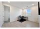 Bright office space featuring modern tile floors, a dedicated desk area, and a wall-mounted television at 17286 W Running Deer Trl, Surprise, AZ 85387
