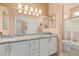Spacious bathroom features double sinks, granite countertops, and white cabinets at 18014 N Calypso Ct, Surprise, AZ 85374