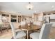 Open-concept dining area featuring a wood table, four chairs, and views of the kitchen and living room at 18014 N Calypso Ct, Surprise, AZ 85374