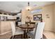 Cozy dining area showcases a wood table, four chairs, and a modern light fixture at 18014 N Calypso Ct, Surprise, AZ 85374