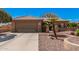 Beautifully landscaped single-story home featuring a spacious two-car garage and easy care landscaping at 18014 N Calypso Ct, Surprise, AZ 85374