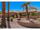 Beautifully landscaped single-story home featuring desert landscaping and mature trees at 18014 N Calypso Ct, Surprise, AZ 85374