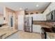 Well-lit kitchen featuring stainless steel appliances, granite countertops, and white cabinets for a modern look at 18014 N Calypso Ct, Surprise, AZ 85374