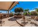 Charming outdoor patio with dining area, built in grill, and a serene, shaded setting at 18014 N Calypso Ct, Surprise, AZ 85374