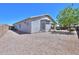 Wide angle view of the backyard featuring gravel landscaping with lush trees under a bright blue sky at 1825 E Sycamore Rd, Casa Grande, AZ 85122