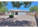 View of the backyard and home exterior showing a gravel landscape with a covered patio at 1825 E Sycamore Rd, Casa Grande, AZ 85122
