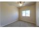 Cozy bedroom featuring neutral carpet, ceiling fan, and bright window at 1825 E Sycamore Rd, Casa Grande, AZ 85122
