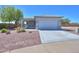 Charming home with desert landscaping, inviting front porch, and a convenient two-car garage, and modern driveway at 1825 E Sycamore Rd, Casa Grande, AZ 85122