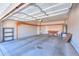 Spacious garage with wood support beams, a utility sink, and ample room for storage and vehicles at 1825 E Sycamore Rd, Casa Grande, AZ 85122